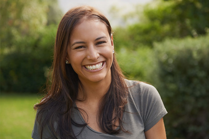 dental patient after periodontal treatment smiling with garden