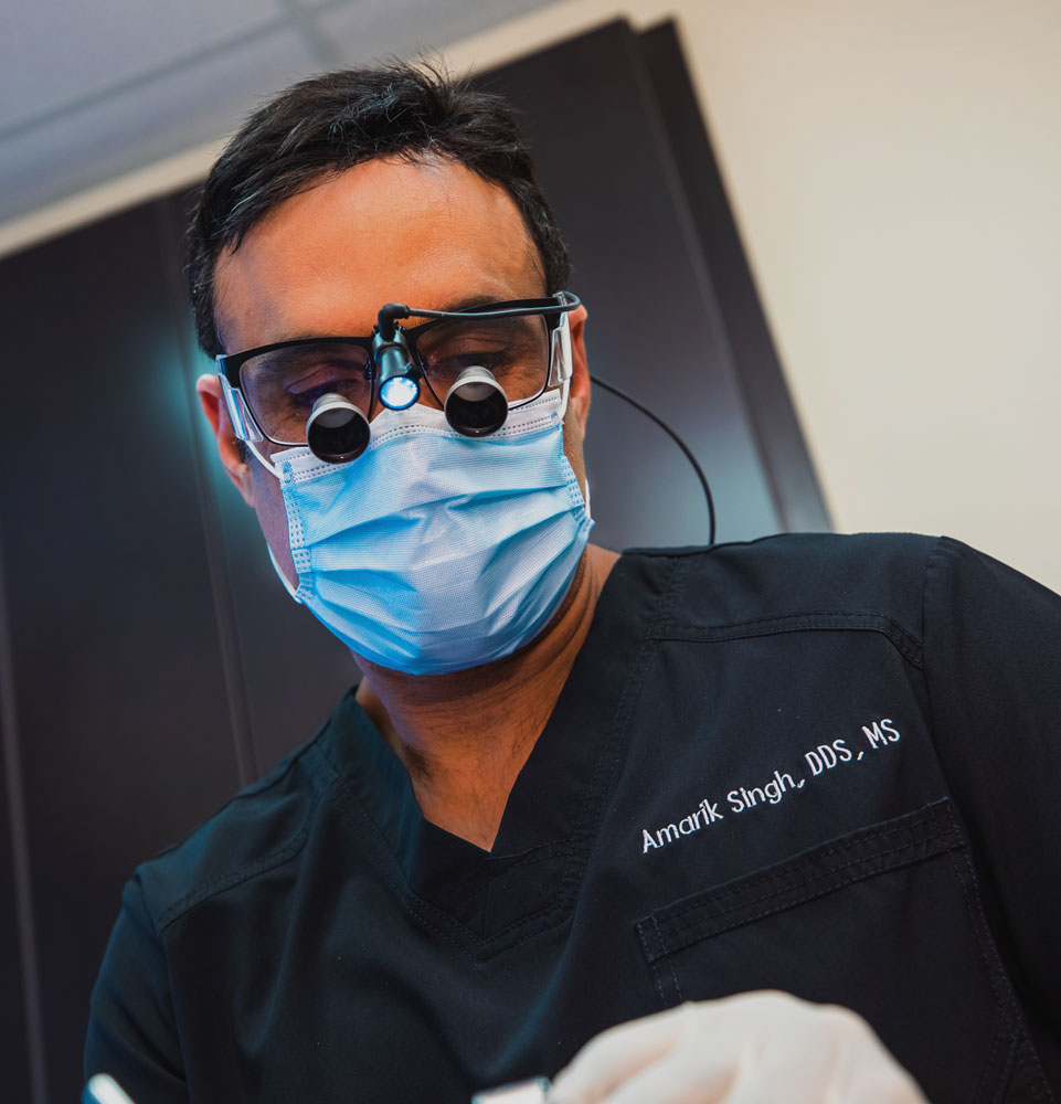 dr amarick singh working on dental patient