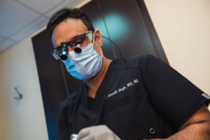 dr singh performing dental procedure
