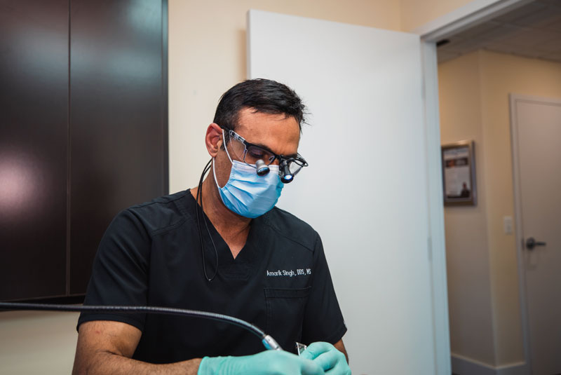 dr singh performing periodontal procedure