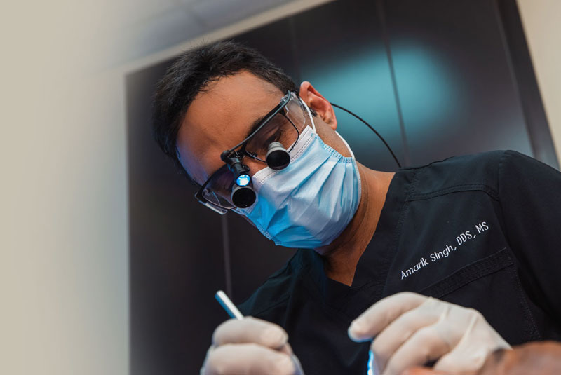 dr singh performing dental procedure