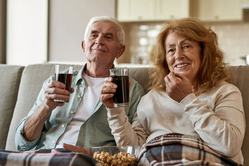 Two Dental Patients Eating And Drinking Using Their New Full Arch Dental Implants