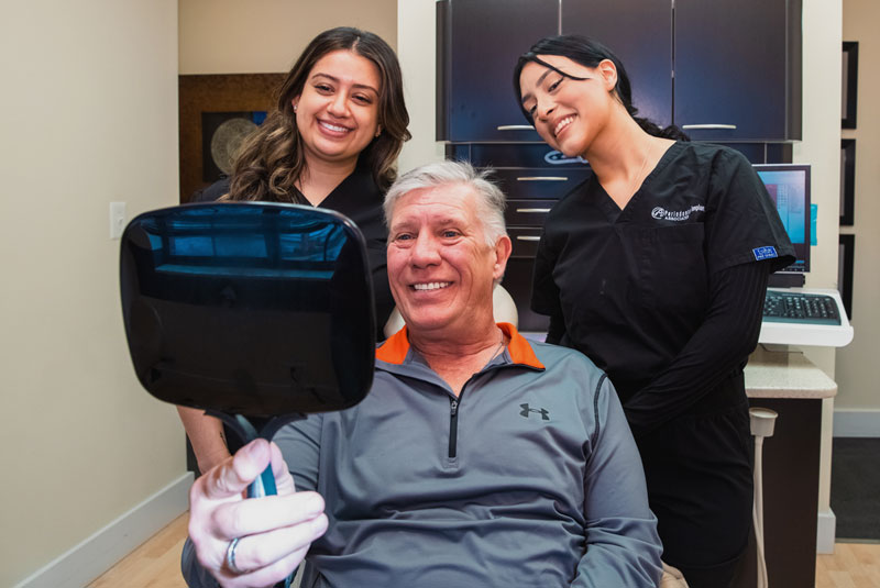 our patient Larry smiling after his dental implants procedure