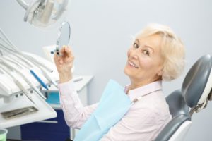 woman sitting in dental chair getting ready to get dental implants