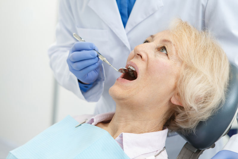 a dental patient undergoing peri-implantitis treatment.